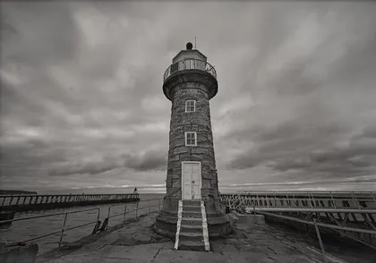 Whitby Lighthouse, a black and white photograph from around the UK
